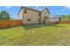 Backyard with a green lawn and wood fence, showcasing the home's outdoor space at 105 Tanners Ct, Covington, GA 30016