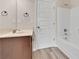 Neutral bathroom featuring a vanity, mirror, and bathtub at 105 Tanners Ct, Covington, GA 30016