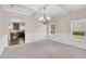 Formal dining room showcasing wainscoting, a coffered ceiling, chandelier, and windows with natural light at 105 Tanners Ct, Covington, GA 30016