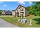 Charming two-story home featuring well-manicured lawn, mature trees, and classic architectural details at 105 Tanners Ct, Covington, GA 30016
