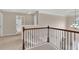 Upstairs hallway featuring a decorative wrought iron railing and views of the home's interior at 105 Tanners Ct, Covington, GA 30016