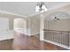 Upstairs hall with hardwood floors and views to rooms with carpet at 105 Tanners Ct, Covington, GA 30016