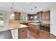 Contemporary kitchen with stainless steel appliances, granite counters, wooden cabinets, and hardwood floors at 105 Tanners Ct, Covington, GA 30016