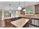 Open kitchen with granite counters, stainless appliances, island and breakfast bar at 105 Tanners Ct, Covington, GA 30016