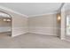 Spacious living area features neutral tones, plush carpet, and seamless transition to adjacent spaces at 105 Tanners Ct, Covington, GA 30016