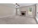Cozy living room with carpet, stone fireplace and natural light at 105 Tanners Ct, Covington, GA 30016