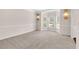 Bright living room boasting neutral carpet, large windows, elegant wall decor, and lots of natural light at 105 Tanners Ct, Covington, GA 30016