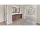 Well-lit main bathroom features a double vanity and tiled flooring, seamlessly connected to main bedroom at 105 Tanners Ct, Covington, GA 30016