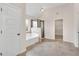 Bright main bathroom features a soaking tub, tiled shower, and modern fixtures at 105 Tanners Ct, Covington, GA 30016