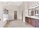 Bright main bathroom boasts double vanity sinks, spacious layout, and convenient access to walk-in closet at 105 Tanners Ct, Covington, GA 30016