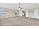 Spacious main bedroom with neutral tones, fan, and large windows, seamlessly connecting to the ensuite bathroom at 105 Tanners Ct, Covington, GA 30016