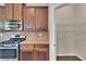 Kitchen features stainless appliances, granite counters and convenient pantry at 105 Tanners Ct, Covington, GA 30016