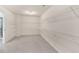 Spacious walk-in closet featuring ample shelving and neutral carpeting at 105 Tanners Ct, Covington, GA 30016