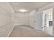 Spacious walk-in closet featuring ample shelving and neutral carpeting leading to the bathroom at 105 Tanners Ct, Covington, GA 30016