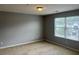 Bedroom featuring carpet, large window, neutral colored walls and ceiling light at 14301 Waldrop Cv, Decatur, GA 30034