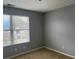 This carpeted bedroom features gray walls and a bright window at 14301 Waldrop Cv, Decatur, GA 30034