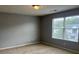Bedroom featuring carpet, large window, neutral colored walls and ceiling light at 14301 Waldrop Cv, Decatur, GA 30034