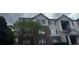Exterior view of a three story building with brick and beige siding and multiple windows at 14301 Waldrop Cv, Decatur, GA 30034