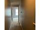 Hallway view leading to a bedroom with gray walls and carpeted floors at 14301 Waldrop Cv, Decatur, GA 30034