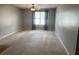 Living room features carpeted floors, a ceiling fan, and a large window at 14301 Waldrop Cv, Decatur, GA 30034