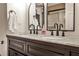 Elegant bathroom featuring double sinks, marble countertop, and modern faucets at 2474 Lehaven Dr, Tucker, GA 30084