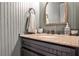 Charming powder room with granite countertop, bronze faucet, and elegant mirror at 2474 Lehaven Dr, Tucker, GA 30084