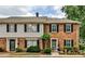 Charming townhouse with brick facade, complemented by dark shutters and manicured landscaping at 2474 Lehaven Dr, Tucker, GA 30084