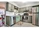 Updated kitchen features stainless steel appliances and stylish green cabinetry with modern hardware at 2474 Lehaven Dr, Tucker, GA 30084
