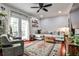 Sunlit living room featuring a plush sectional sofa, a stylish rug, and French doors to outside at 2474 Lehaven Dr, Tucker, GA 30084