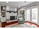 Cozy living room with brick fireplace, built-in shelving and French doors for natural light at 2474 Lehaven Dr, Tucker, GA 30084