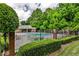 Community pool surrounded by lush greenery and a covered seating area at 2474 Lehaven Dr, Tucker, GA 30084