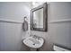 Elegant powder room featuring white wainscoting, a pedestal sink, and a decorative mirror at 57 Forsyth Nw St # 12B, Atlanta, GA 30303