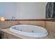 Bright bathroom featuring a deep, luxurious soaking tub and neutral tile surround at 57 Forsyth Nw St # 12B, Atlanta, GA 30303