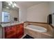Elegant bathroom featuring a soaking tub, granite vanity, and tiled accents at 57 Forsyth Nw St # 12B, Atlanta, GA 30303