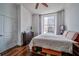 Tranquil bedroom with hardwood floors, ceiling fan, and city views at 57 Forsyth Nw St # 12B, Atlanta, GA 30303