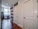 Hallway with hardwood flooring and access to office with built-in shelving at 57 Forsyth Nw St # 12B, Atlanta, GA 30303