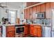 Well-appointed kitchen boasts wood cabinets, granite counters, and stainless appliances at 57 Forsyth Nw St # 12B, Atlanta, GA 30303
