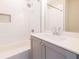 Bathroom with white subway tile in shower/tub combo and gray vanity with white countertop at 915 Katie Kerr Drive, Decatur, GA 30030