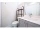 Bathroom featuring a gray vanity with white countertop and black metal shelving unit over the toilet at 915 Katie Kerr Drive, Decatur, GA 30030