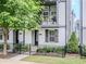 Charming two-story townhome featuring a balcony, black accents, and well-maintained landscaping at 915 Katie Kerr Drive, Decatur, GA 30030
