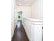 Hallway with hardwood floors, white trim and doors leading to various rooms at 915 Katie Kerr Drive, Decatur, GA 30030