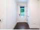 Bright hallway featuring hardwood floors, leading to a door with great view of the greenery outside at 915 Katie Kerr Drive, Decatur, GA 30030