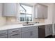 Charming kitchen with light gray cabinets, stone backsplash, stainless steel appliances, and ample counter space at 915 Katie Kerr Drive, Decatur, GA 30030