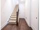 Well-lit staircase with carpeted steps and hardwood floors, leading to the upper level at 915 Katie Kerr Drive, Decatur, GA 30030