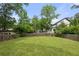 Spacious backyard with a wooden fence, lush green grass, and mature trees, offering privacy and a serene setting at 2824 Tupelo Se St, Atlanta, GA 30317