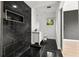 Modern bathroom featuring black tiled shower and white vanity at 2824 Tupelo Se St, Atlanta, GA 30317