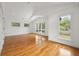 Spacious bedroom with vaulted ceilings, gleaming hardwood floors, and multiple windows with outside views at 2824 Tupelo Se St, Atlanta, GA 30317