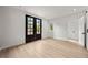Bright room with hardwood floors, windows, and door leading to another area at 2824 Tupelo Se St, Atlanta, GA 30317