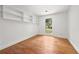 Small bedroom with hardwood floors, built in shelving and a bright window with outside views at 2824 Tupelo Se St, Atlanta, GA 30317