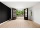 Bright bedroom featuring french doors leading to the outdoor deck and light wood floors at 2824 Tupelo Se St, Atlanta, GA 30317